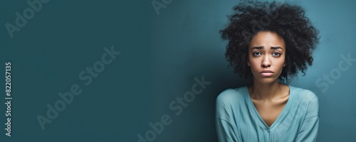Cyan background sad black independant powerful Woman realistic person portrait of young beautiful bad mood expression girl Isolated on Background racism  photo
