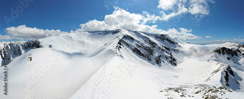 Obraz na płótnie Panoramic view of Rila National Park, Bulgaria. Snow in the mountains. Famous place for hiking and mountaineering. w salonie