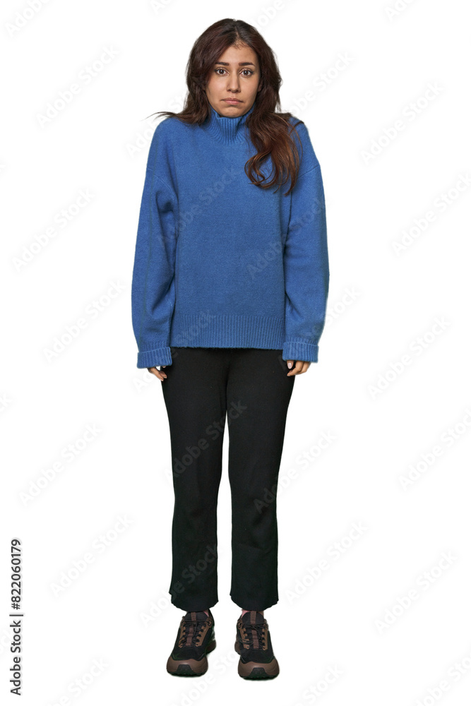 Fototapeta premium Middle Eastern woman, full body studio shrugs shoulders and open eyes confused.
