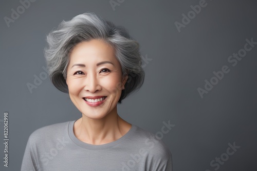 Gray Background Happy Asian Woman Portrait of Beautiful Older Mid Aged Mature Smiling Woman good mood Isolated