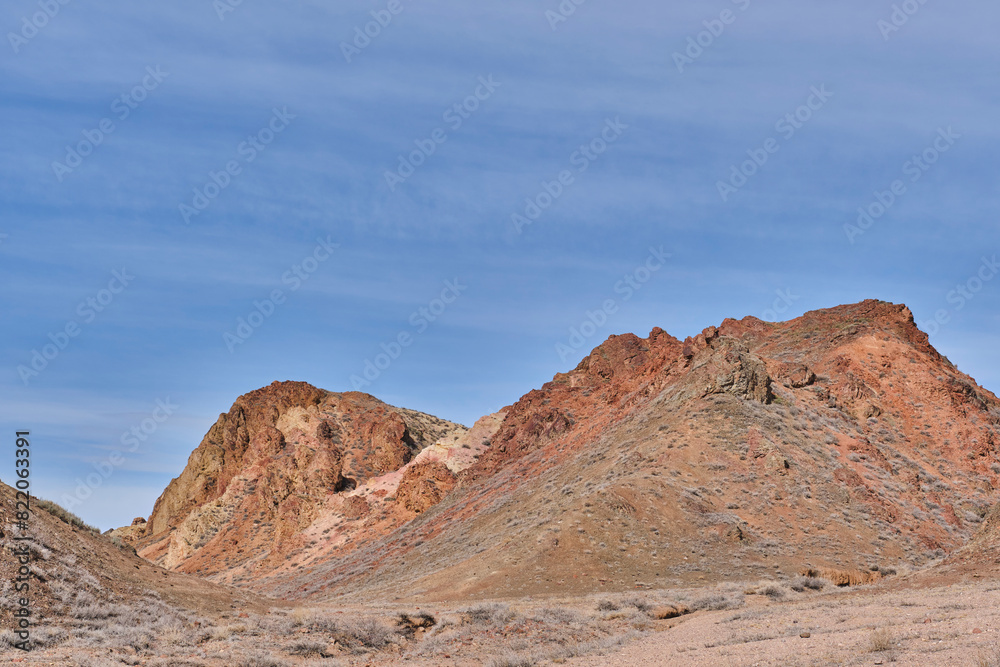 Colored soil of hills over background of blue sky in Charyn Canyon National Park in Kazakhstan.