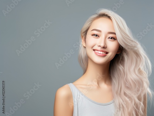 Gray background Happy Asian Woman Portrait of young beautiful Smiling Woman good mood Isolated on Background Skin Care Face Beauty Product Banner with copyspace 