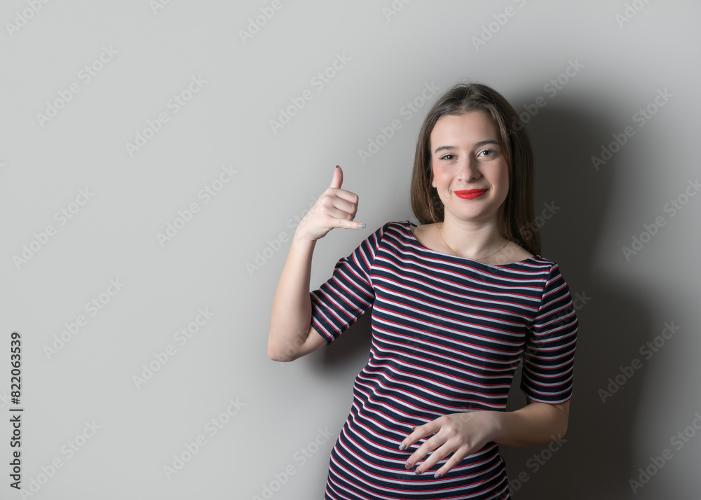 Obraz premium Smiling cute girl in a dress on bright background.