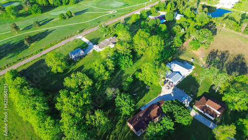 Farm houses on large acreage rural lots lush greenery trees, large storage shed in Mountain Grove Missouri, farmland and ranches in the Midwest peaceful countryside agricultural area, aerial view