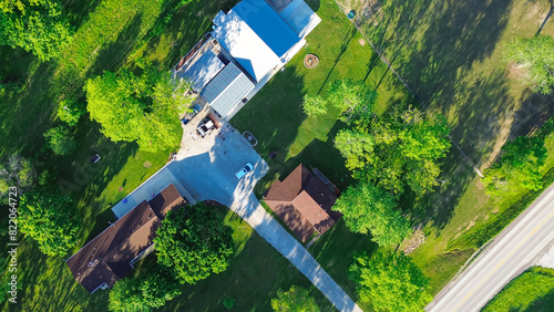 Obraz na plátně Direct aerial view farm houses with long driveway, large storage sheds, acreage