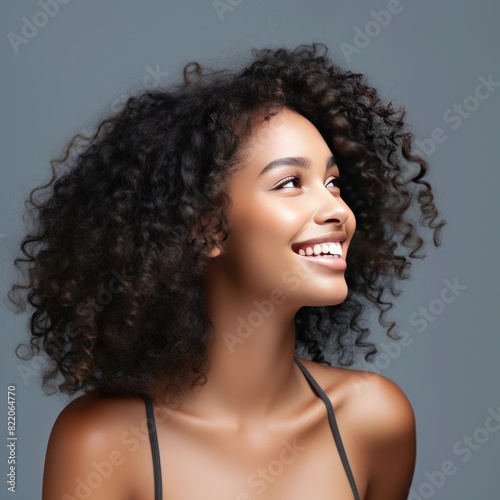 Gray background Happy black independant powerful Woman Portrait of young beautiful Smiling girl good mood Isolated on Background Skin Care Face Beauty