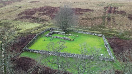 Ascending drone footage of the Chapel at Hermitage in Hermitage Water valley, Scotland, UK photo