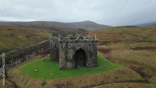 Drone footage of the Hermitage Castle on a cloudy day, Scotland, United Kingdom photo