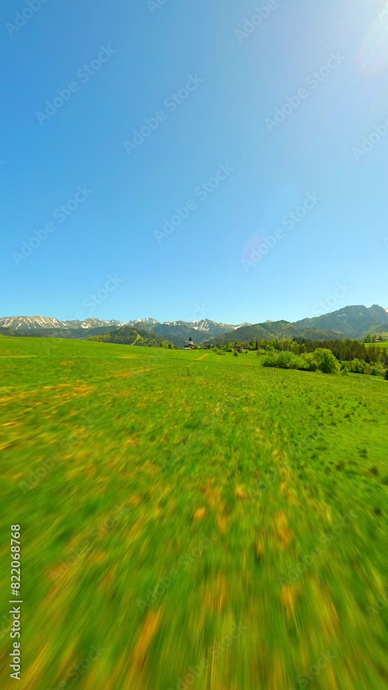 FPV flight over green meadow near the Tatra mountains in summer, Poland FPV flight over green meadow near the Tatra mountains in summer, Poland