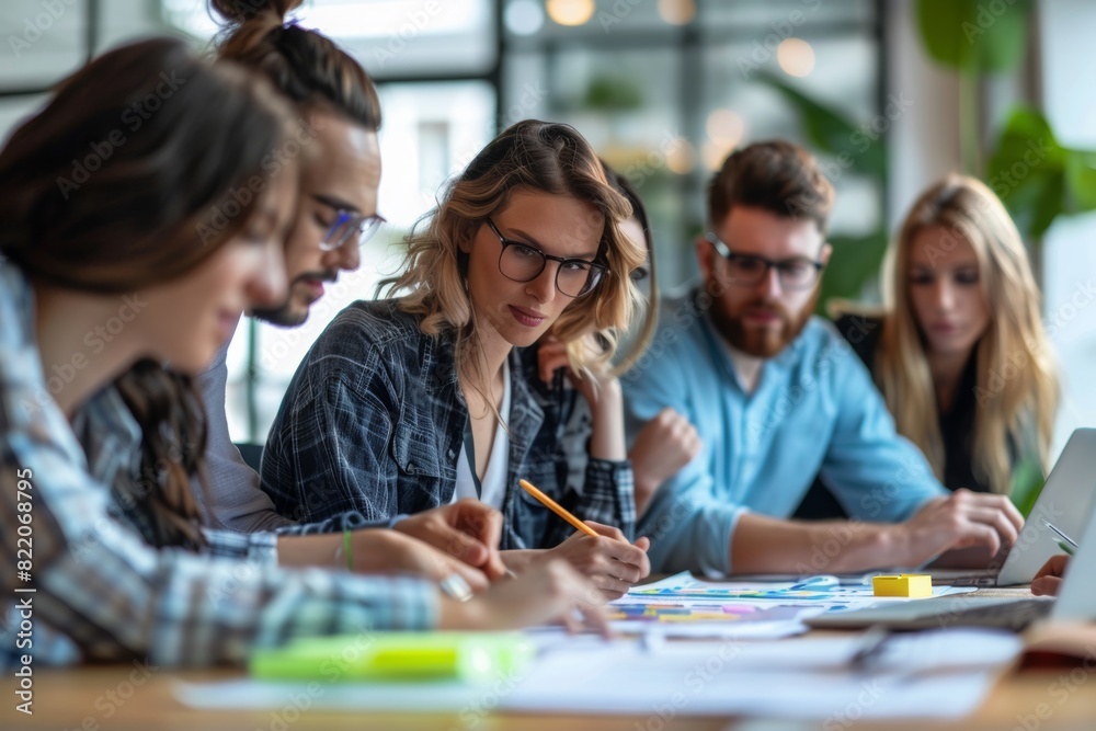 Group of young professionals brainstorming in a modern office setting, engaged in a collaborative and creative process.
Group of young professionals brainstorming in a modern office setting, engaged in a collaborative and creative process.