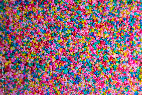 Top view of vibrant multicolored sprinkles © Wirestock