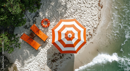 Aerial view of beach chairs and umbrella on sandy shore near the ocean, with green foliage. Light and shadow play on sand. Summer vacation concept. Generative AI