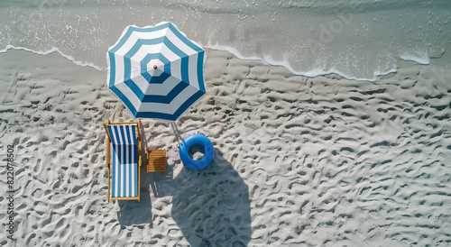 Beach scene with umbrella, chair, and float on sandy shore, top view. Holiday concept. Generative AI