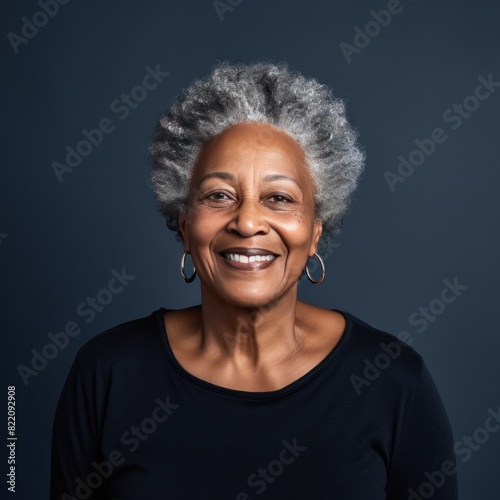 Navy Background Happy black american independant powerful Woman. Portrait of older mid aged person beautiful Smiling girl Isolated on Background ethnic diversity  © Zickert