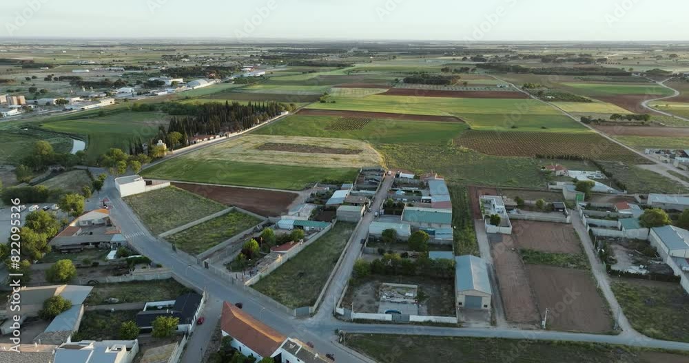 Aerial view of patchwork fields and village homes in San Clemente, Cuenca, Castilla - La Mancha, Spain.