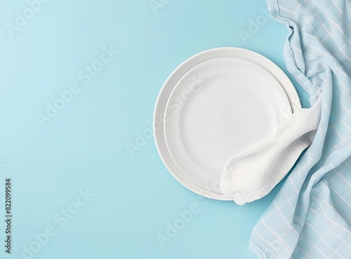  A white plate and napkin on blue background