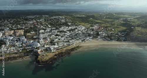 Aerial view of coastal town with beach and residential buildings, Praia da Luz, Algarve region, Portugal. photo