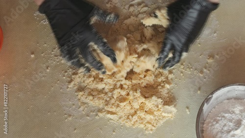 Mixing shortbread dough on the table. Mixing butter and dough until a thick homogeneous mass is formed