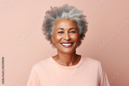 Peach Background Happy black american independant powerful man. Portrait of older mid aged person beautiful Smiling boy Isolated on Background ethnic diversity 