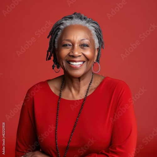 Red Background Happy black american independant powerful Woman. Portrait of older mid aged person beautiful Smiling girl Isolated on Background ethnic diversity