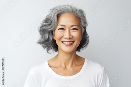 Silver Background Happy Asian Woman Portrait of Beautiful Older Mid Aged Mature Smiling Woman good mood Isolated Anti-aging Skin Care Face Beauty Product Banner with copyspace 