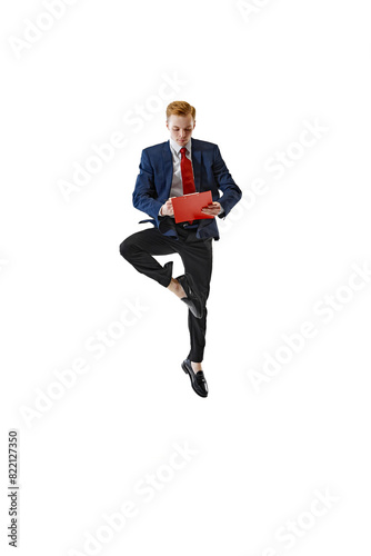Focused on work young man in formal attire stands in yoga tree pose and holds folder against white studio background. Concept of business, work and study, hobby, freelance, office. Ad © Lustre Art Group 