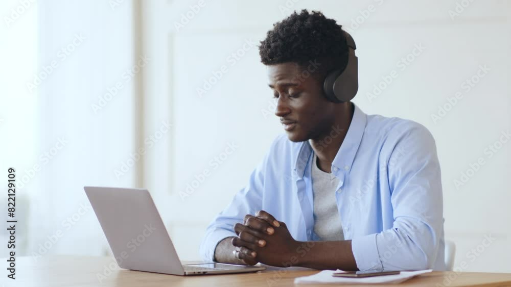 Online employment. Young african man having job interview on laptop Online employment. Young african man having job interview on laptop