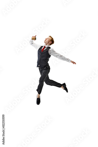 Dynamic shot of young man dressed smart casual outfit drinks coffee while running, harry up to work against white studio background. Concept of business, work and study, hobby, freelance, office. Ad