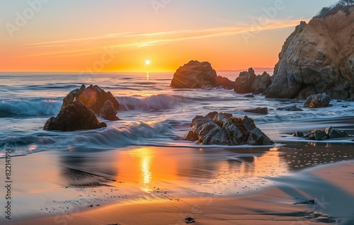 Beautiful sunrise over the beach with rocks and waves