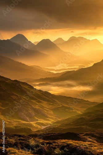 A majestic mountain range bathed in the golden light of sunrise  mist swirling in the valleys below