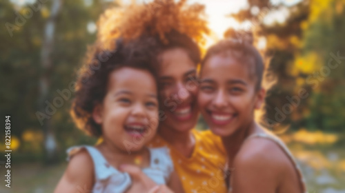 Blurred Portrait of Multiracial Lesbian Mothers with Daughter in Park
