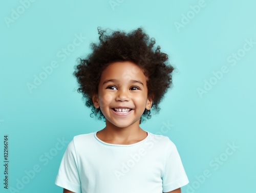 Aqua background Happy black american african child Portrait of young beautiful kid Isolated on Background ethnic diversity equality acceptance concept with copyspace