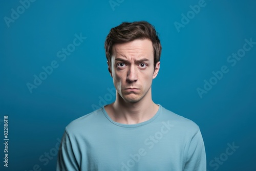 Blue background sad european white man realistic person portrait of young beautiful bad mood expression man Isolated on Background depression anxiety fear burn out health issue problem mental 