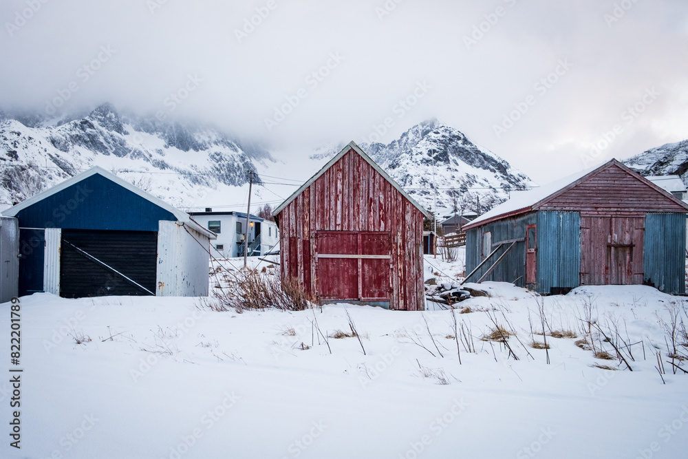Red barn in snowy mountains in Norther Norway