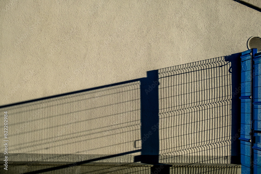 The shadow of the fence on the stone wall. The shadow of the fence on the stone wall.