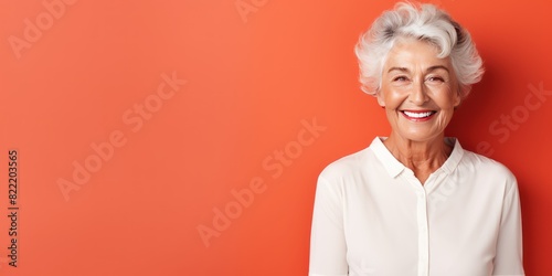 Coral background Happy european white Woman grandmother realistic person portrait of young beautiful Smiling Woman Isolated on Background Banner with copyspace