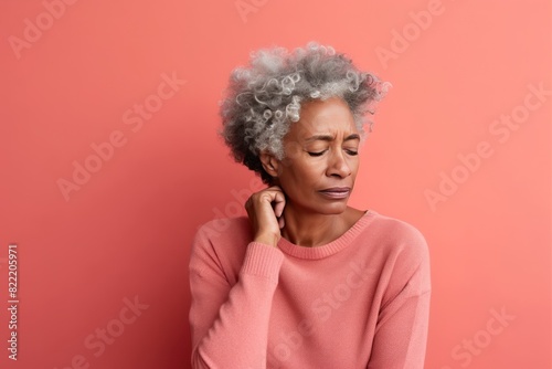 Coral background sad black American independent powerful Woman. Portrait of older mid-aged person beautiful bad mood expression girl Isolated on Background racism skin color depression anxiety fear bu