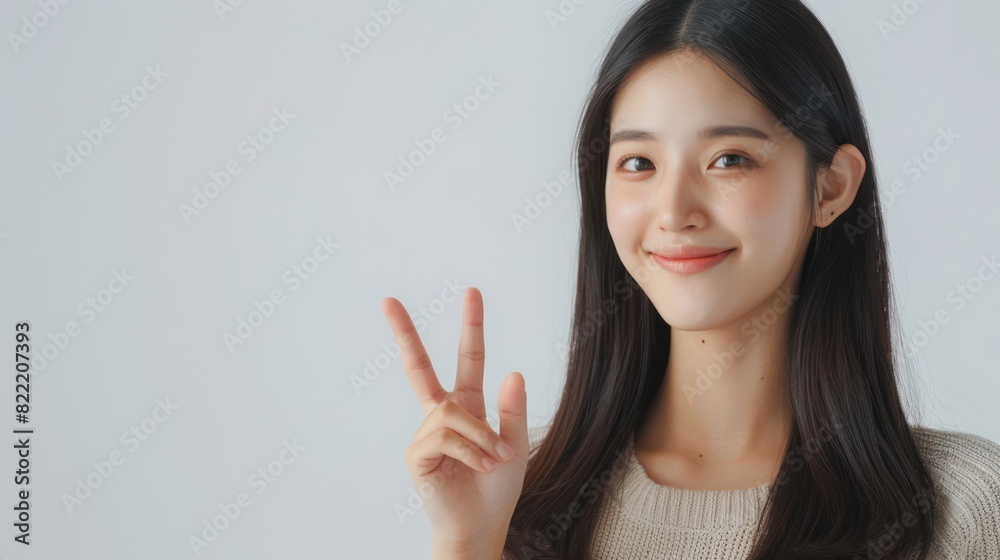 Asian woman pointing at empty space, looking at camera with smiling face, happy as if she found a satisfying product. Used for advertising, isolated on white background. Asian woman pointing at empty space, looking at camera with smiling face, happy as if she found a satisfying product. Used for advertising, isolated on white background.