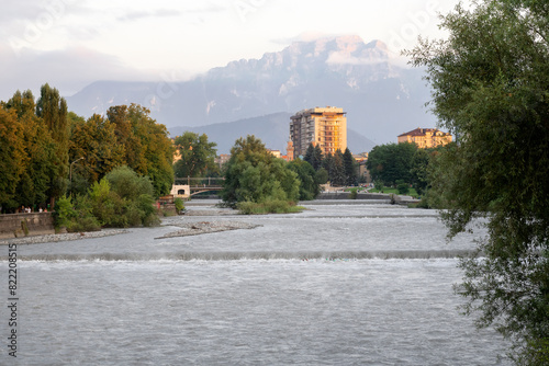 The Terek River, the Sunni Mosque and the Vladikavkaz Hotel on the background of Table Mountain on a summer evening. Vladikavkaz, North Ossetia, Russia photo