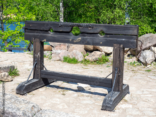 Closeup of a wooden pillory. Medieval pillory for public punishment and torture. The tool of torture for punishment in the Middle Ages photo