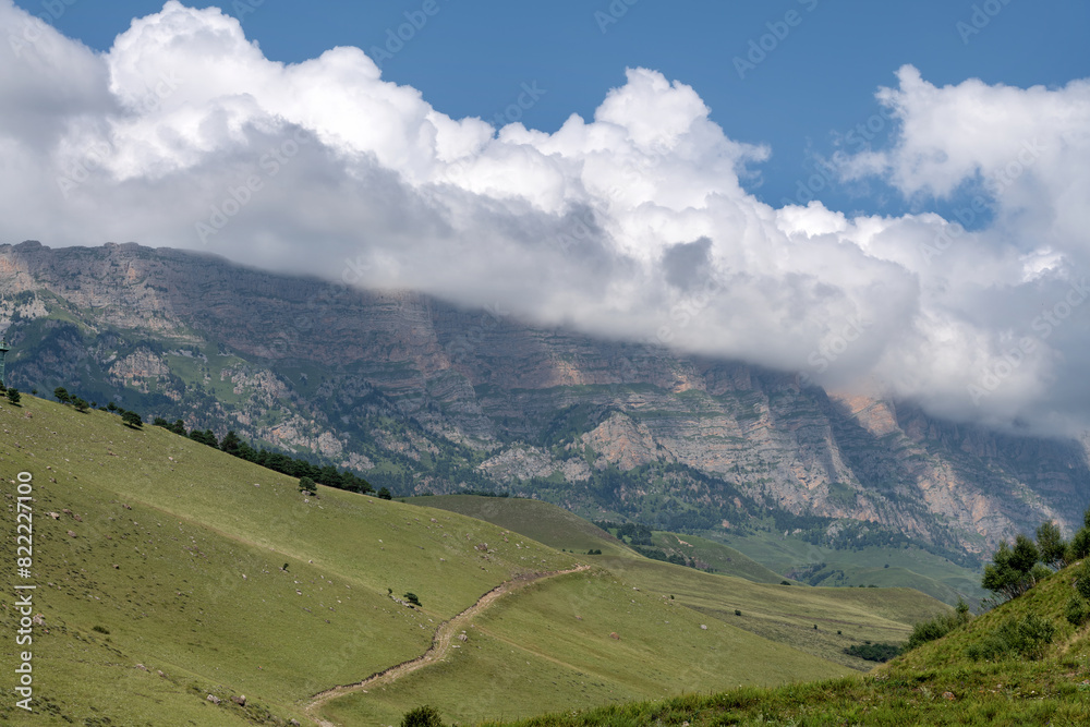 Clouds cover the peaks of the mountains. View of the Caucasus Mountains in Ingushetia, Russia Clouds cover the peaks of the mountains. View of the Caucasus Mountains in Ingushetia, Russia