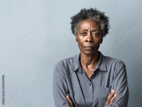 Ivory background sad black American independent powerful Woman. Portrait of older mid-aged person beautiful bad mood expression girl Isolated  © Zickert