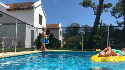 Children at swimming pool setting, holiday summer vacations