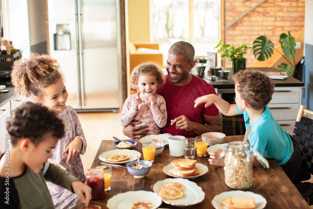 Father having breakfast with children at home Father having breakfast with children at home