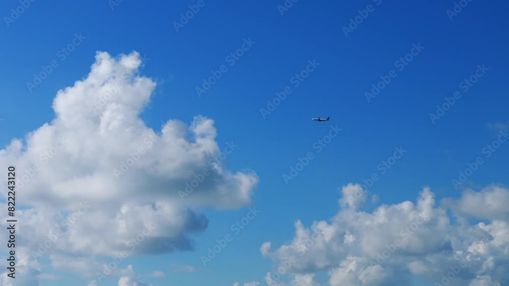 Clear blue sky with scattered lush white clouds and quickly airplane flying at high altitude. Concept of transportation and landscapes Clear blue sky with scattered lush white clouds and quickly airplane flying at high altitude. Concept of transportation and landscapes