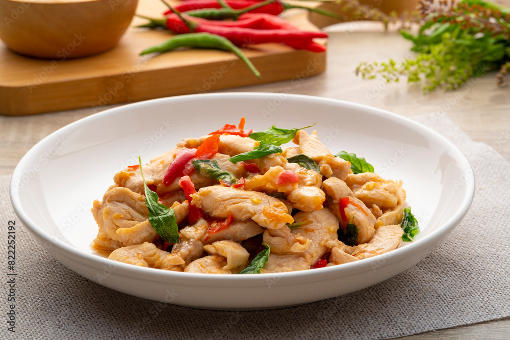 Close up Stir-Fried sliced chicken breast with Basil on white plate Close up Stir-Fried sliced chicken breast with Basil on white plate