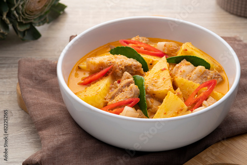 Thai Red curry Pineapple with Sliced Pork Belly in white bowl