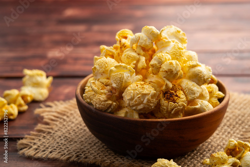 Popcorn in a bowl.Salt flavored popcorn in wooden bowl on wood table background