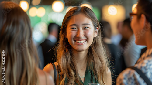 networking at alumni reception or post-graduation event, with laughter, conversation, sense of camaraderie. Spirit of community, connection captured as graduates reflect on shared experiences