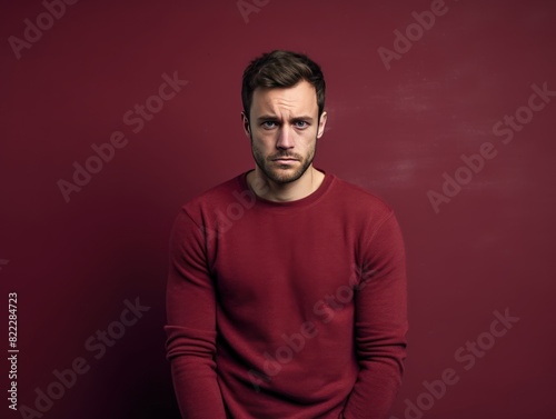 Maroon background sad european white man realistic person portrait of young beautiful bad mood expression man Isolated on Background depression anxiety 